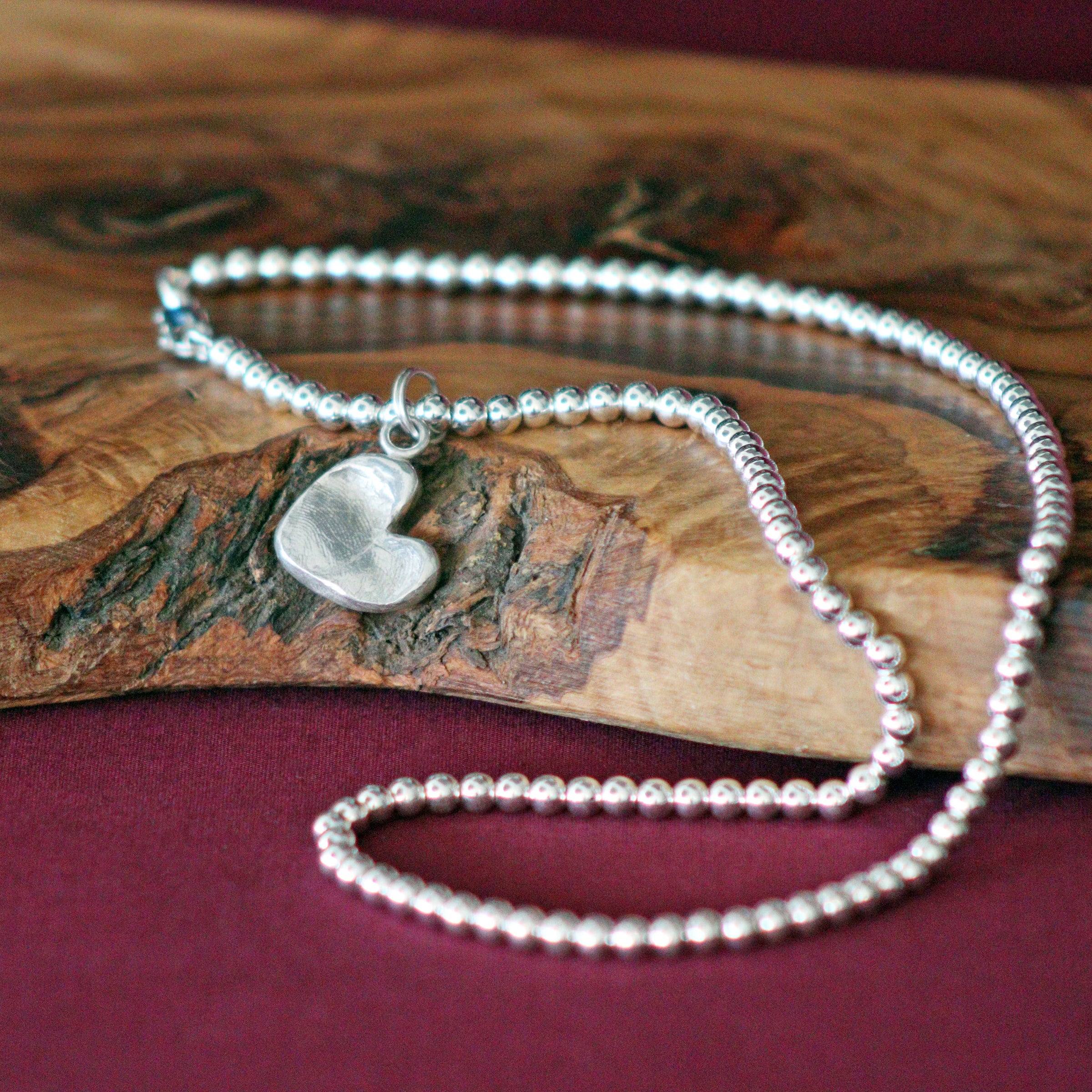A small ball that can go on a necklace 2025